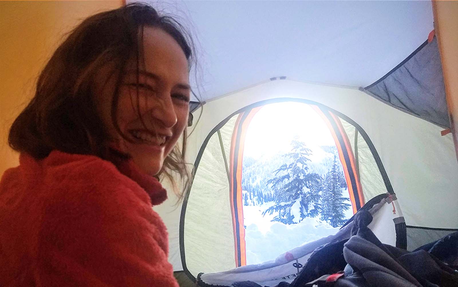 A woman smiling in a tent