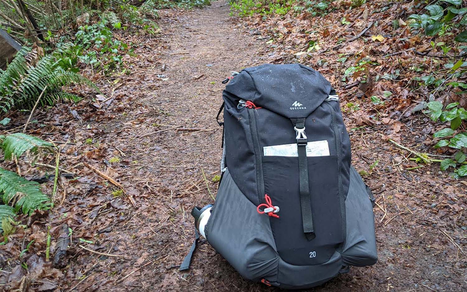 A grey best backpack sitting on a trail