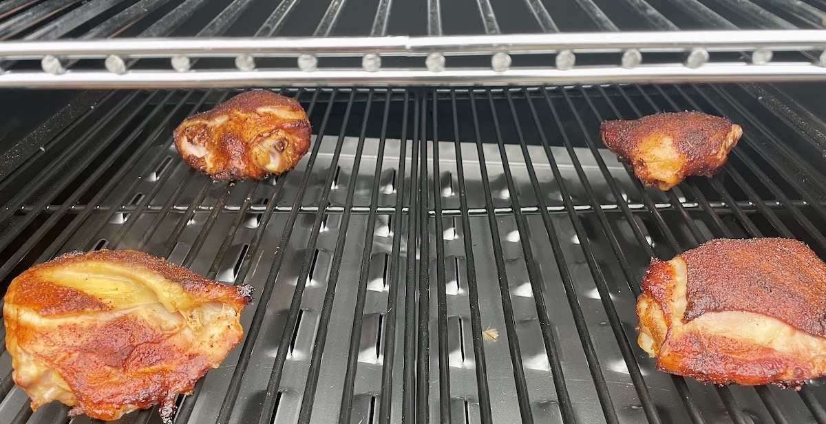 Four chicken thighs on one of the best pellet smokers