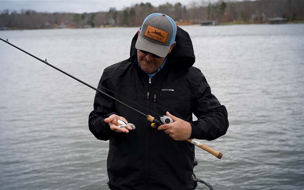 A man on the water holding a best spinnerbait rod