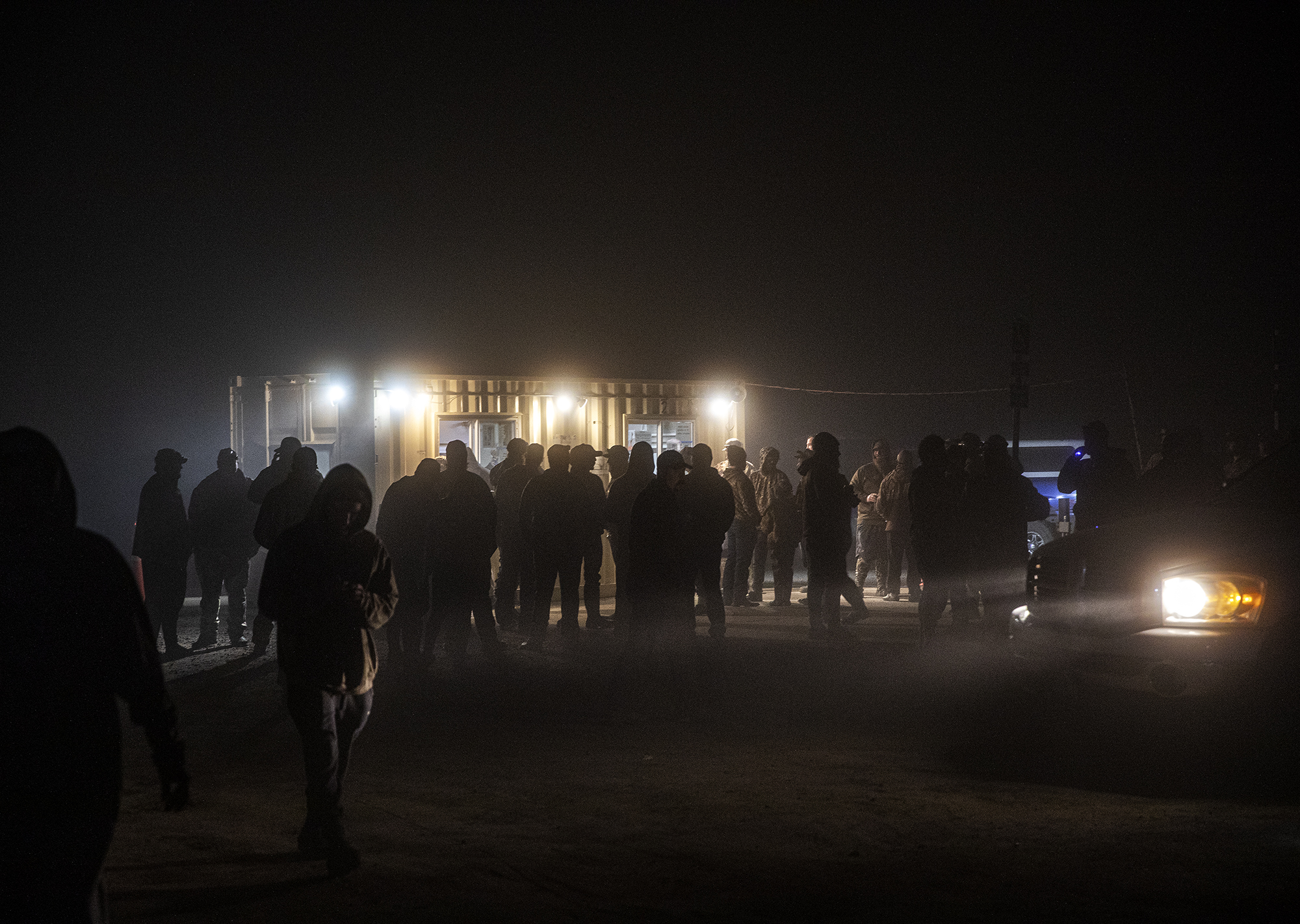 Hunters line up for a duck blind lottery in darkness. Photo by Tom Fowlks