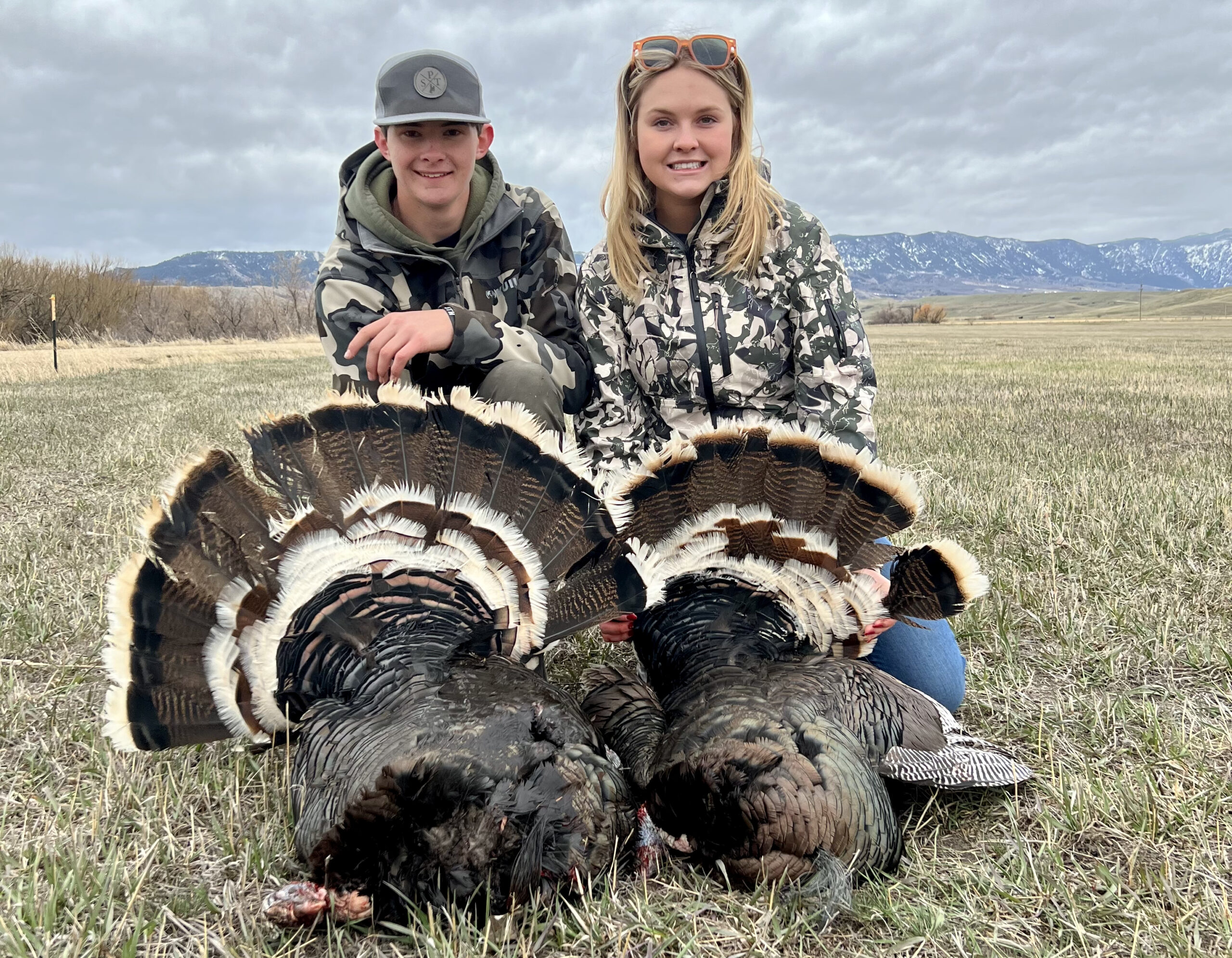 Two Wyoming teens with their turkeys before prom night.