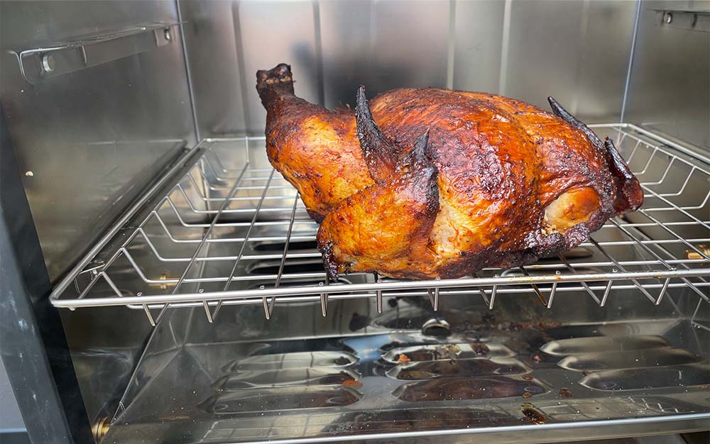 A whole chicken smoked on the Bradley 4 Rack.