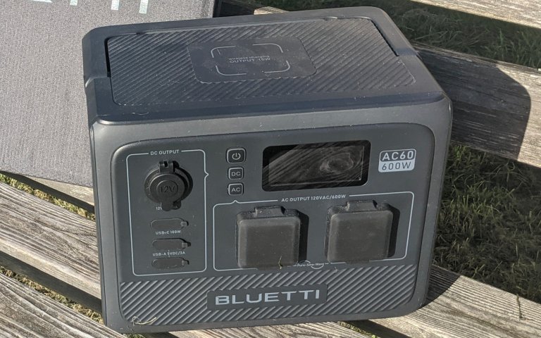 bluetti Pioneer 50 sitting on a park bench