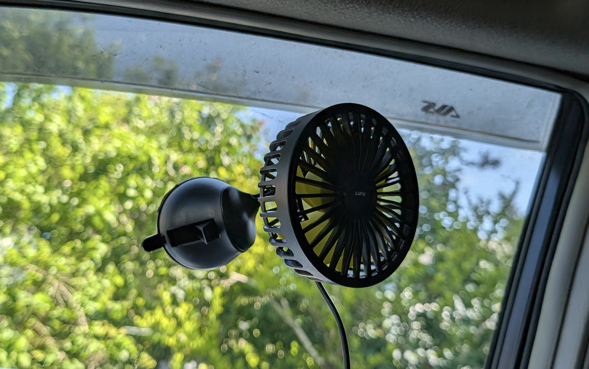 Luno camping fan attached to a car window