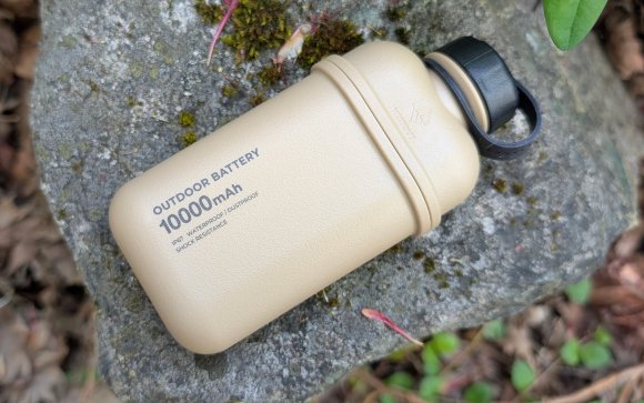 Nestout power bank sitting on a rock