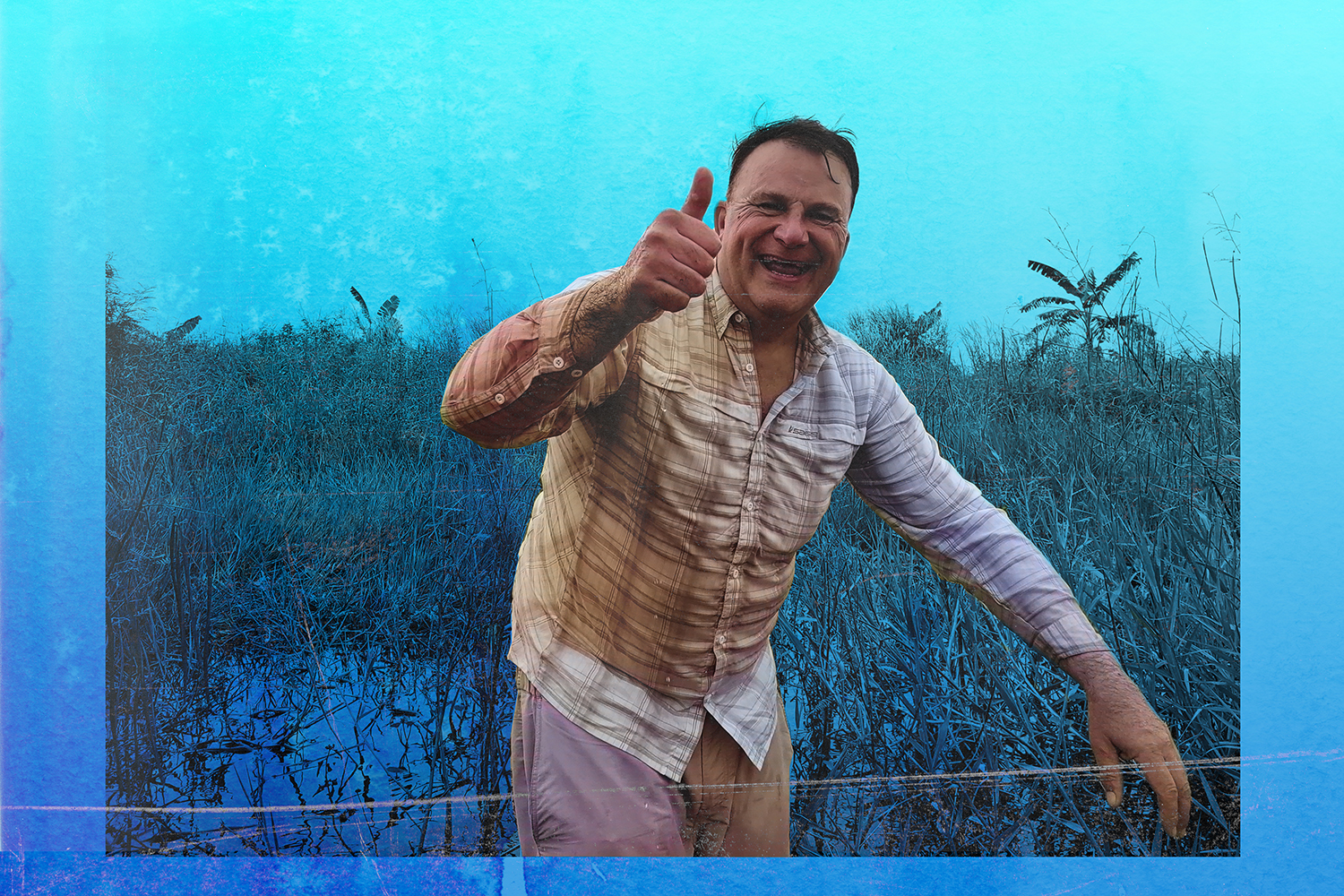 Angler in swampy area gives thumbs-up