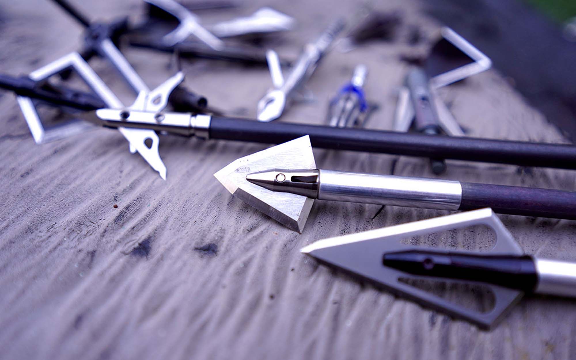 The different types of broadheads laying on table.