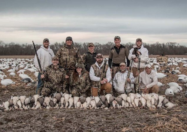Group of hunters posing in front of the best snow goose decoys.