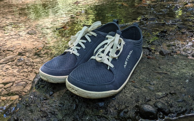 Astral Loyak shoes on a rock in the middle of a stream