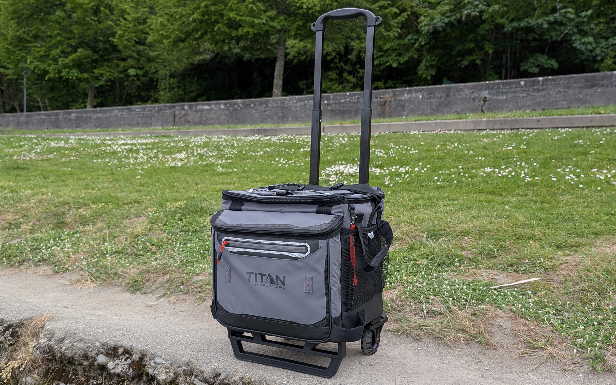 Titan wheeled cooler set against a grassy background