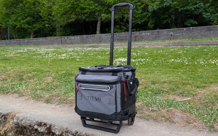 Titan wheeled cooler set against a grassy background