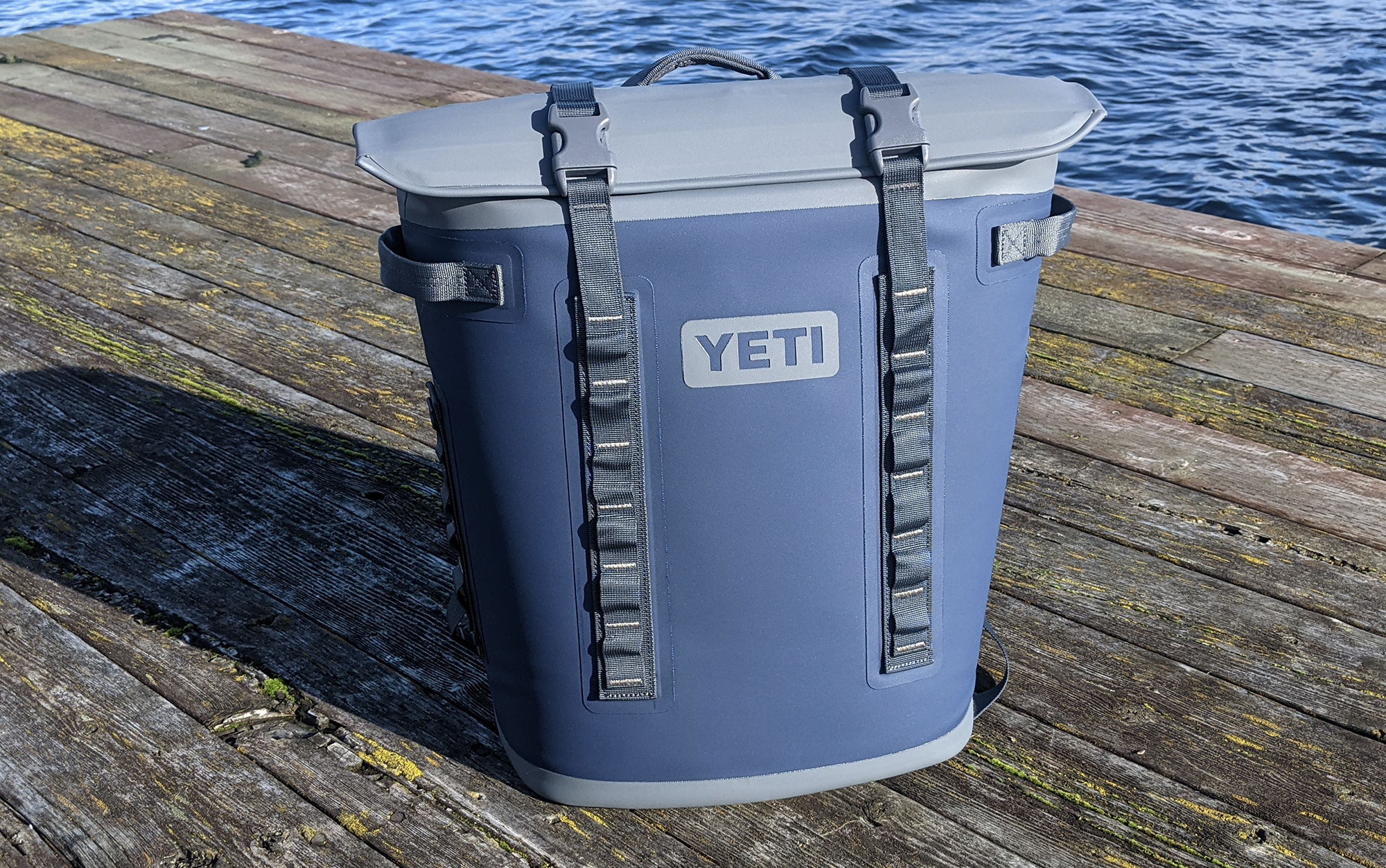 Yeti Hopper backpack cooler sitting on a dock