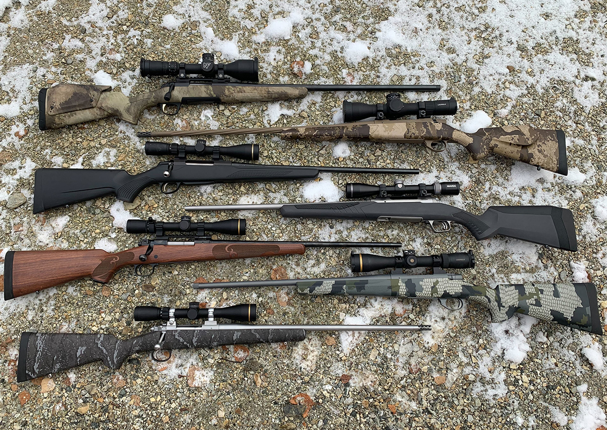 The best mid-priced hunting rifles are laying on snowy rocks.