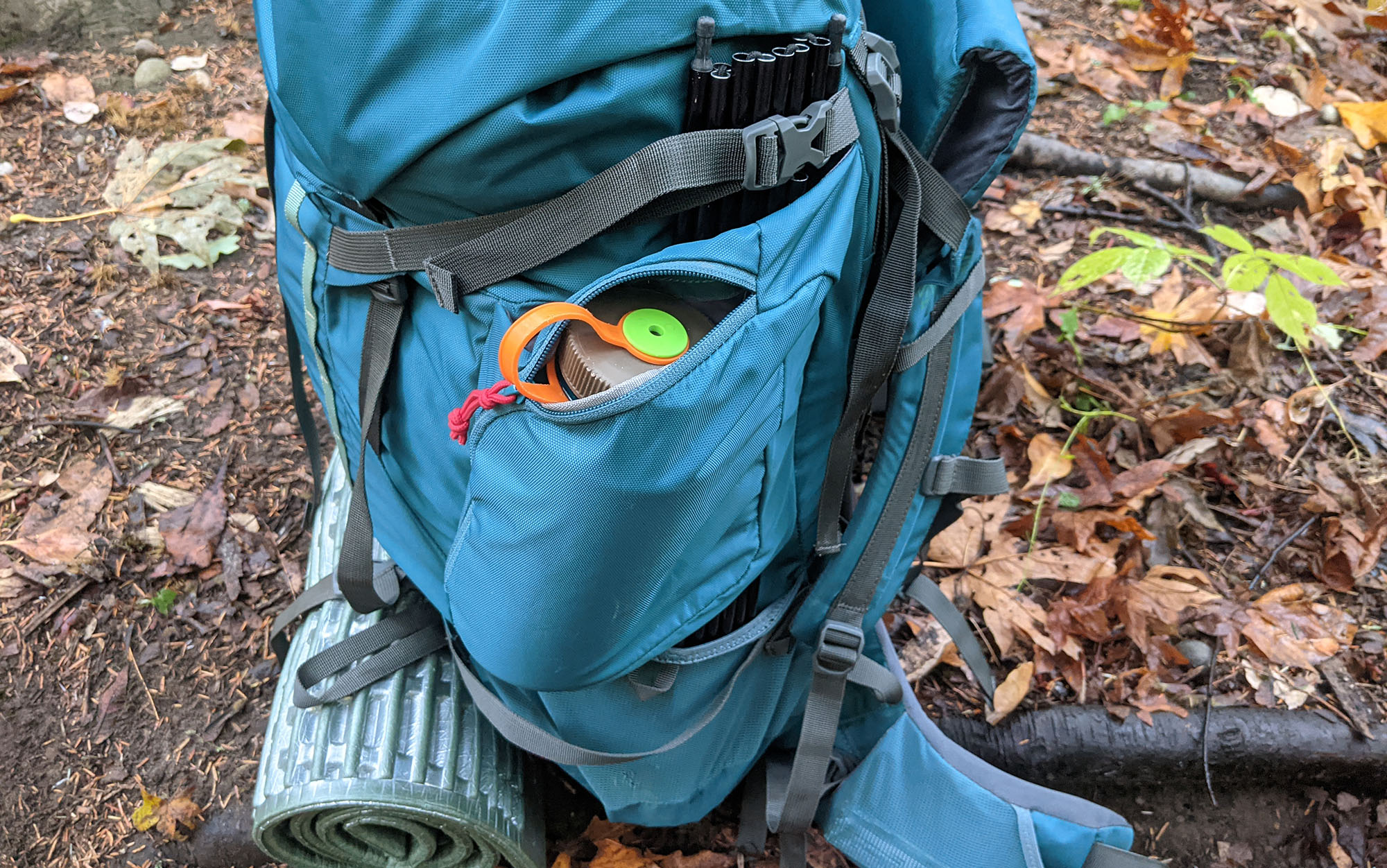 The zip pockets on each side of the Kelty Coyote was large enough to fit a Nalgene bottle (and then some), while still allowing tent poles to slide behind the pocket. A compression strap at the top provides extra security for poles as well as providing stability for unusually large loads.