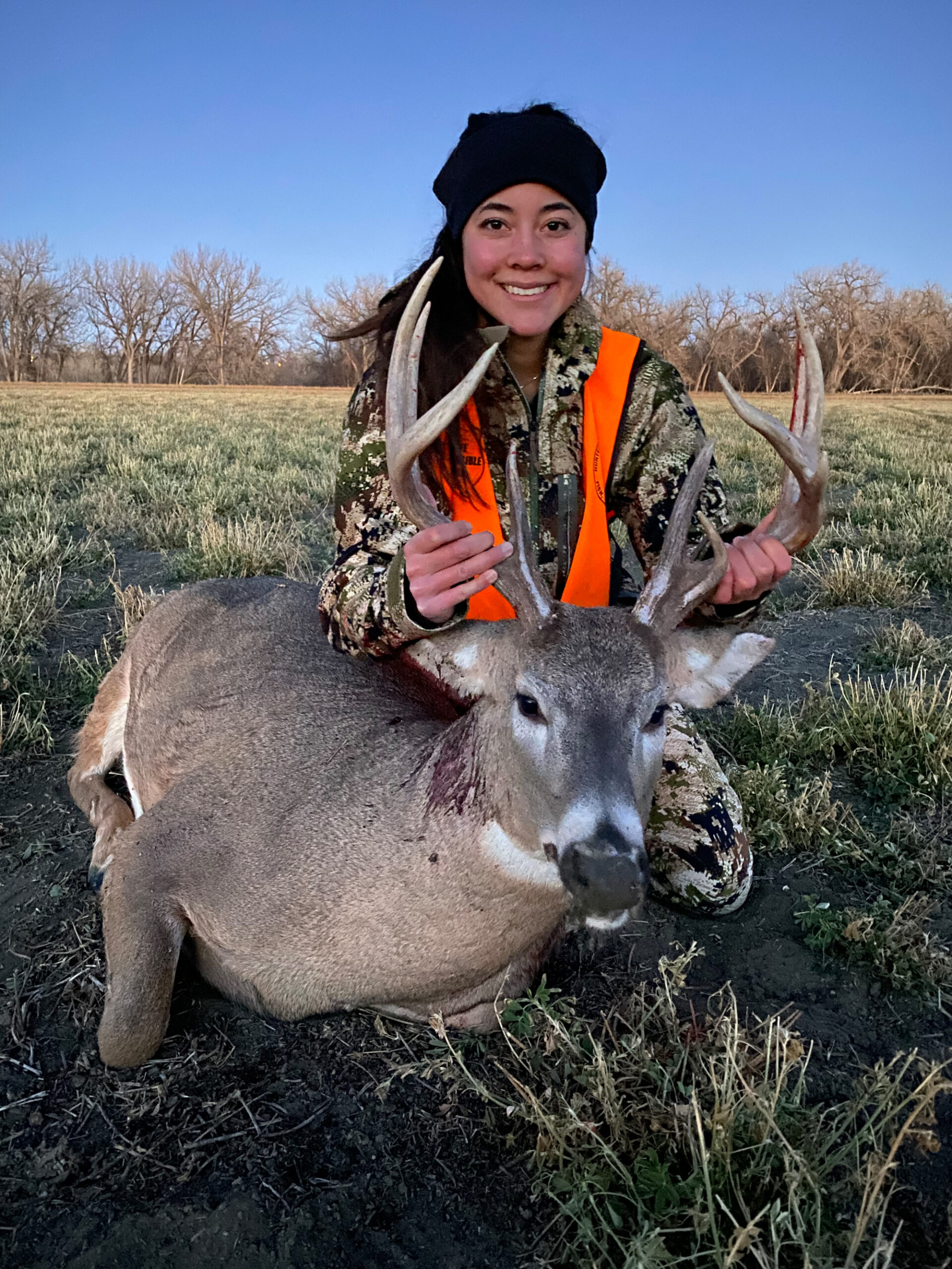 A young hunter with her Montana whitetail buck.