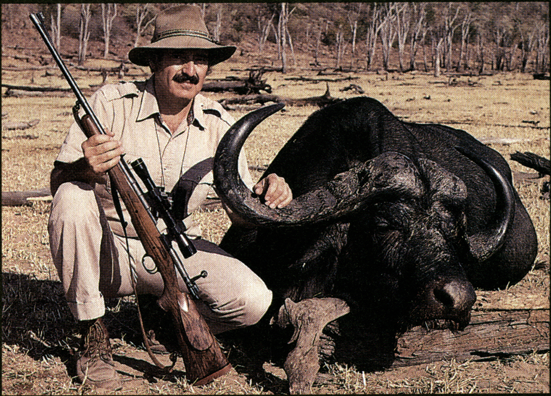 Jim Carmichel poses with rifle and cape buffalo.