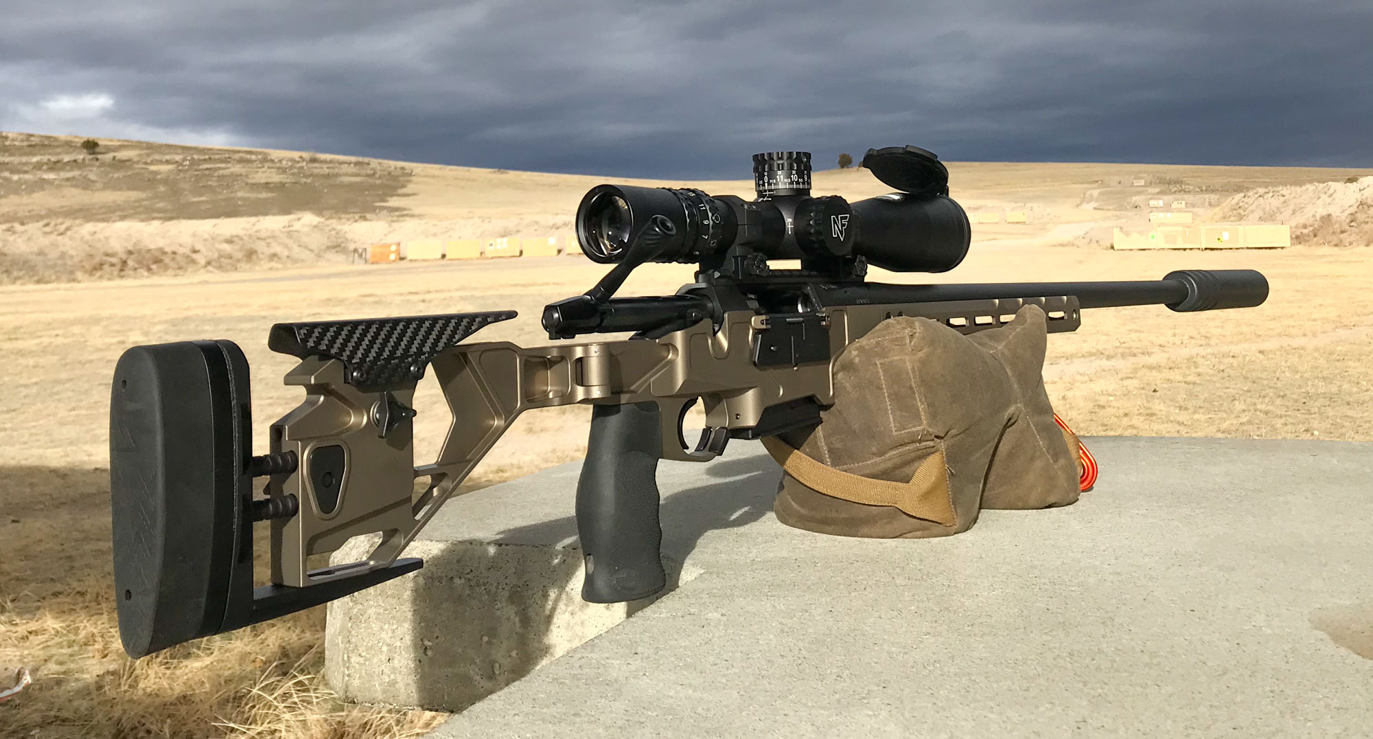 Precision rifle balanced on a bag at a shooting range
