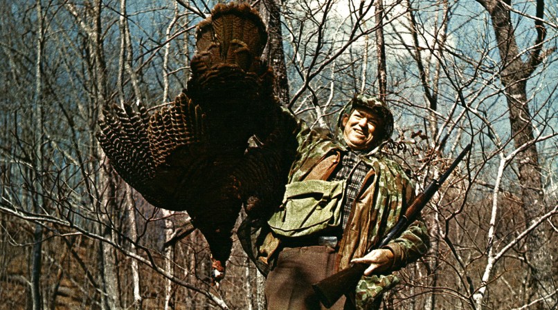 Hunter holding up turkey.