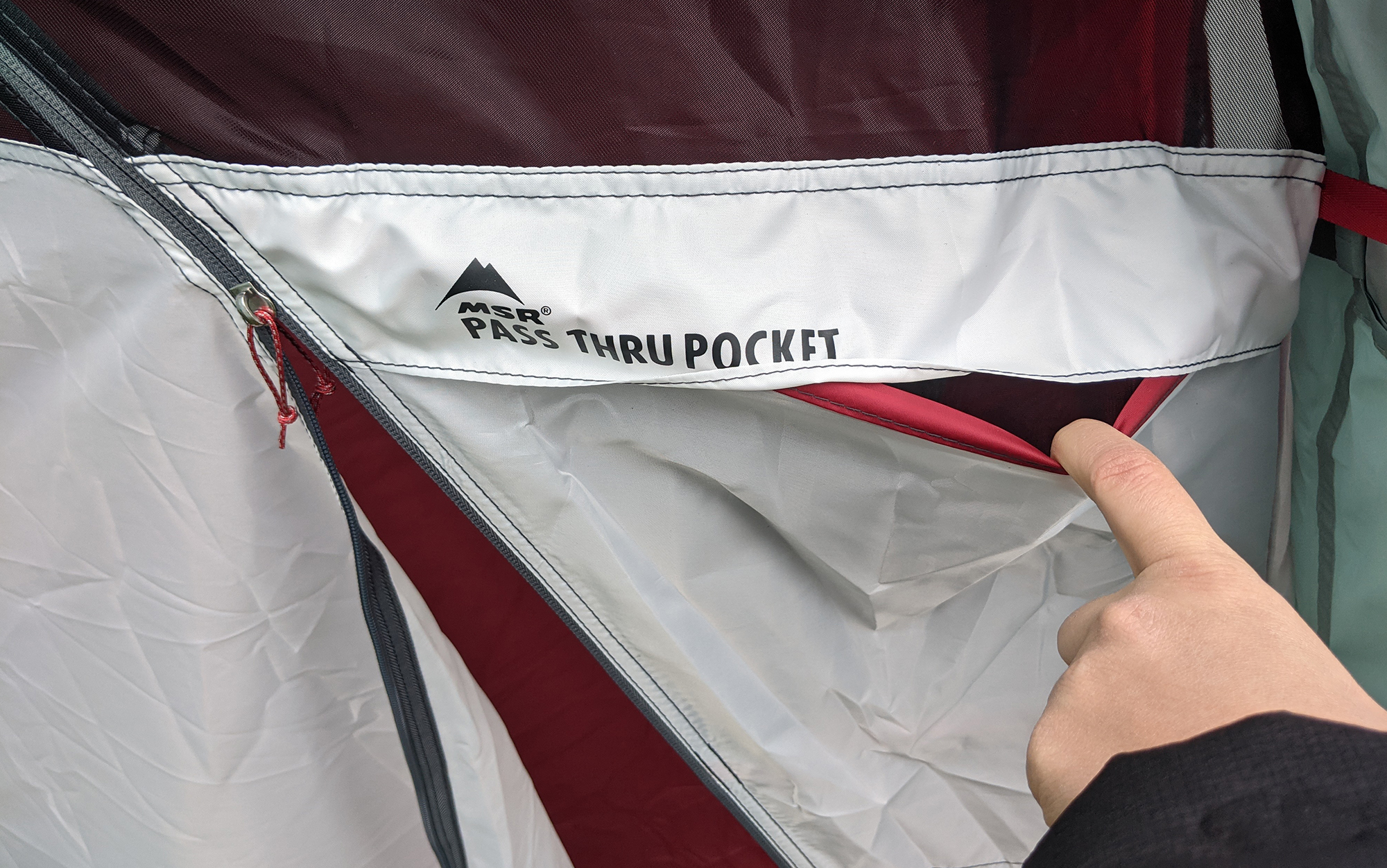 Grabbing your phone, sunglasses, or sunscreen out of the tent just got a lot easier with the MSR Habiscape’s pass-through pocket.