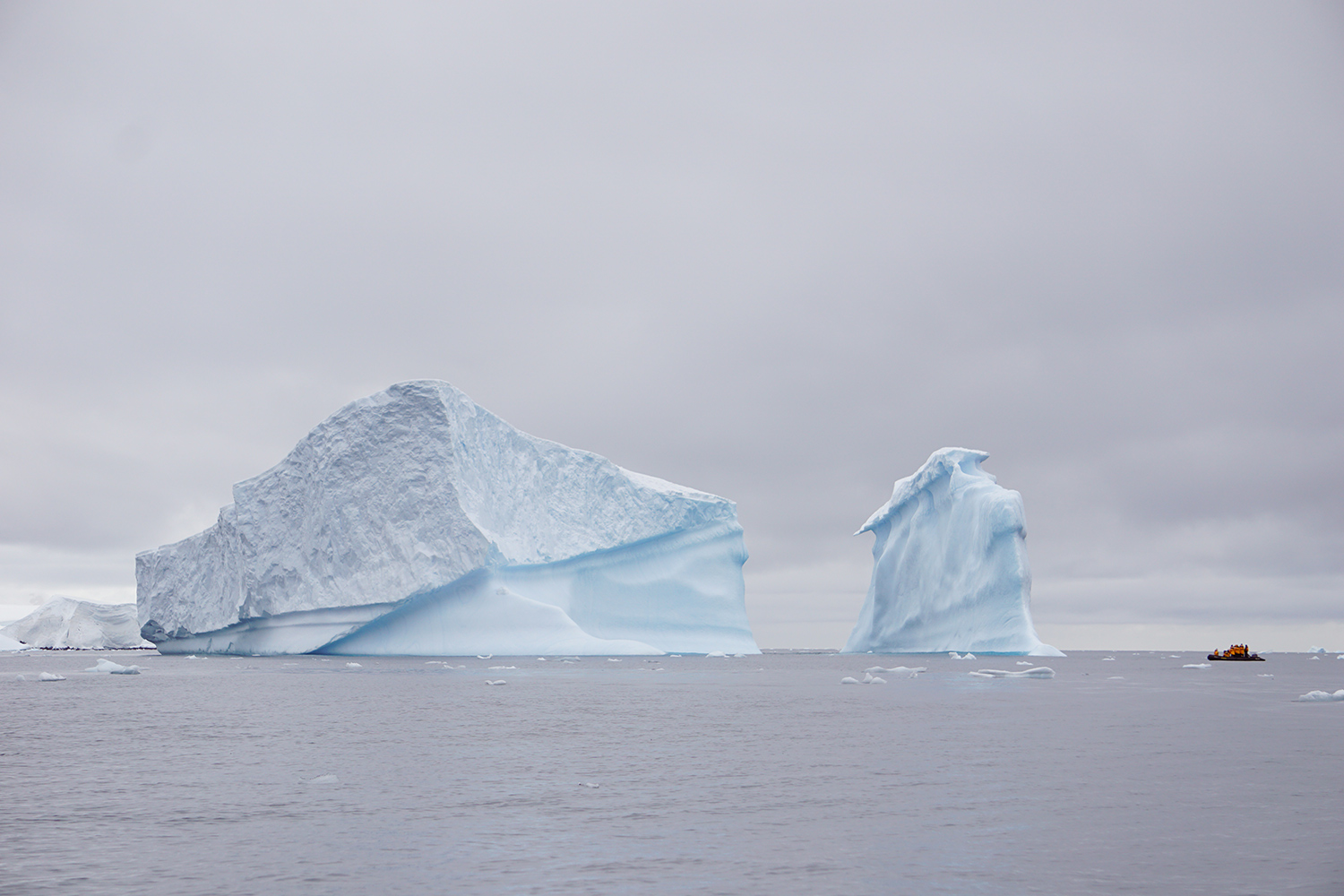 kayak near pieces of antarctic iceberg