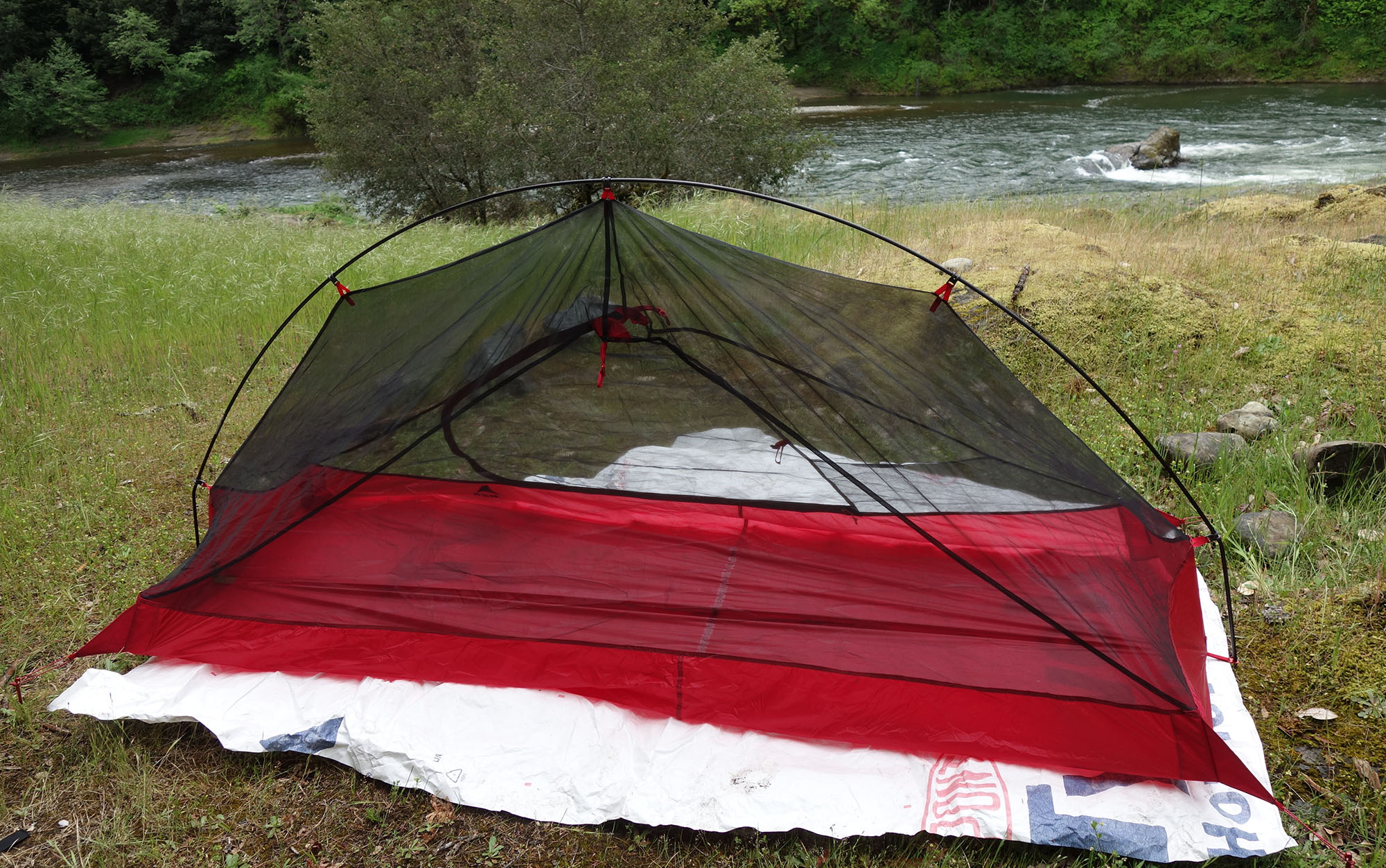 A tent is set up on a footprint.