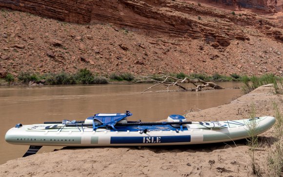 Isle Switch sitting on a sandy beach by a desert river