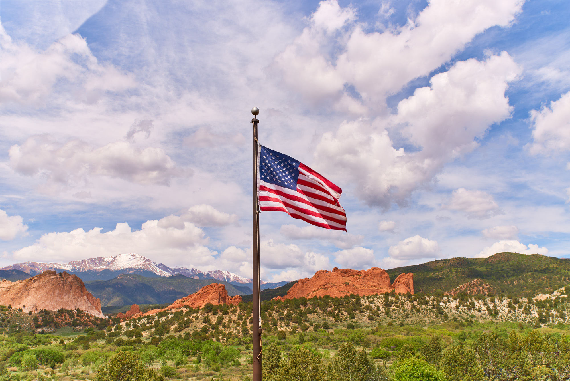 An American flag flying above the front range ofColorado