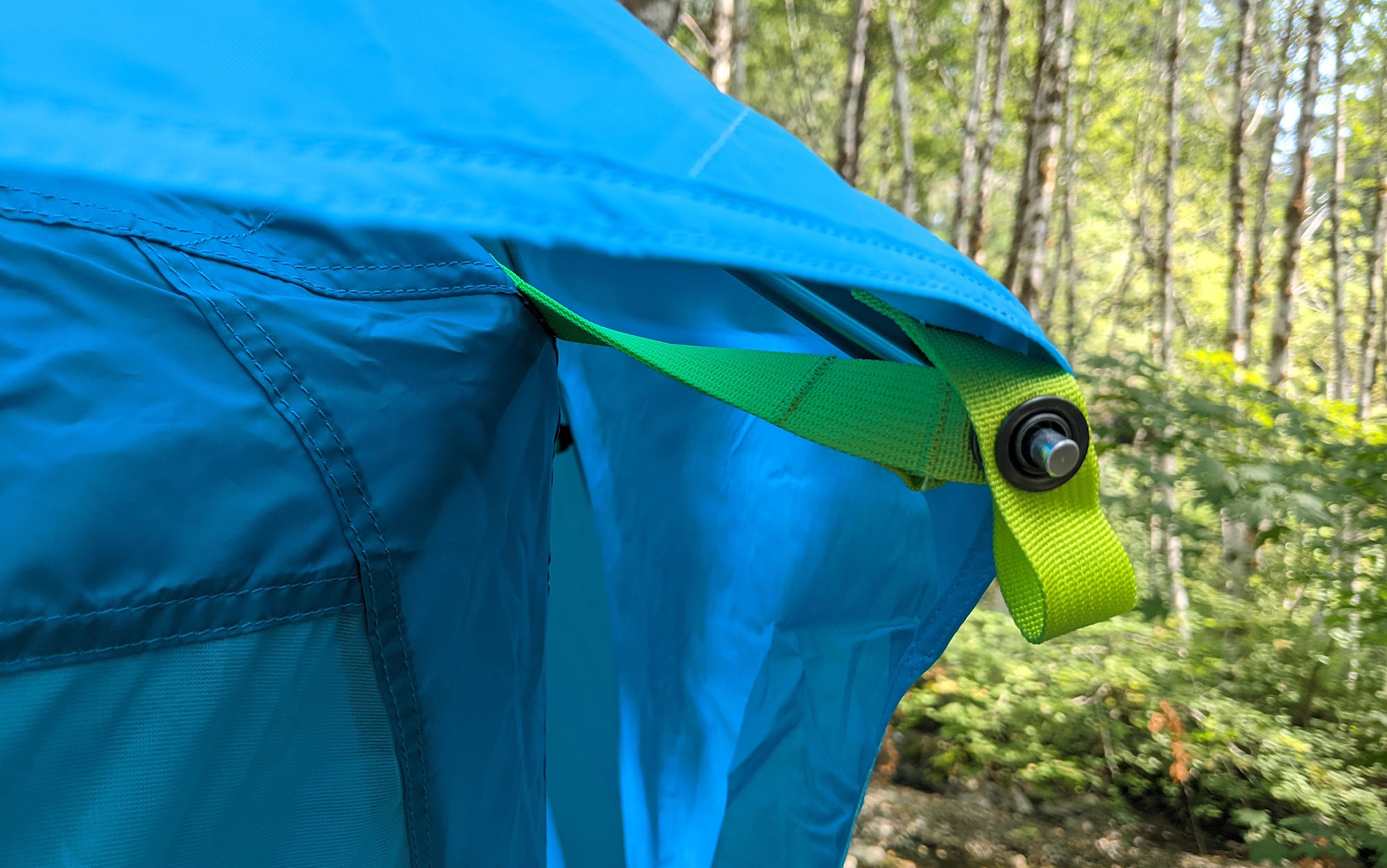 The rainfly for the NEMO Aurora Highrise 6P tent is held taut by the two lengthwise poles, which helps with protection from the elements even if you can’t properly stake out the rain fly in tough ground.
