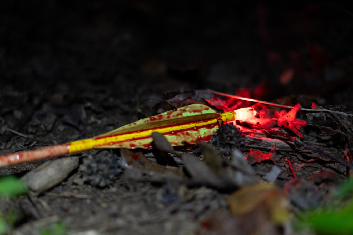 A lighted nock on the ground after going through a deer.