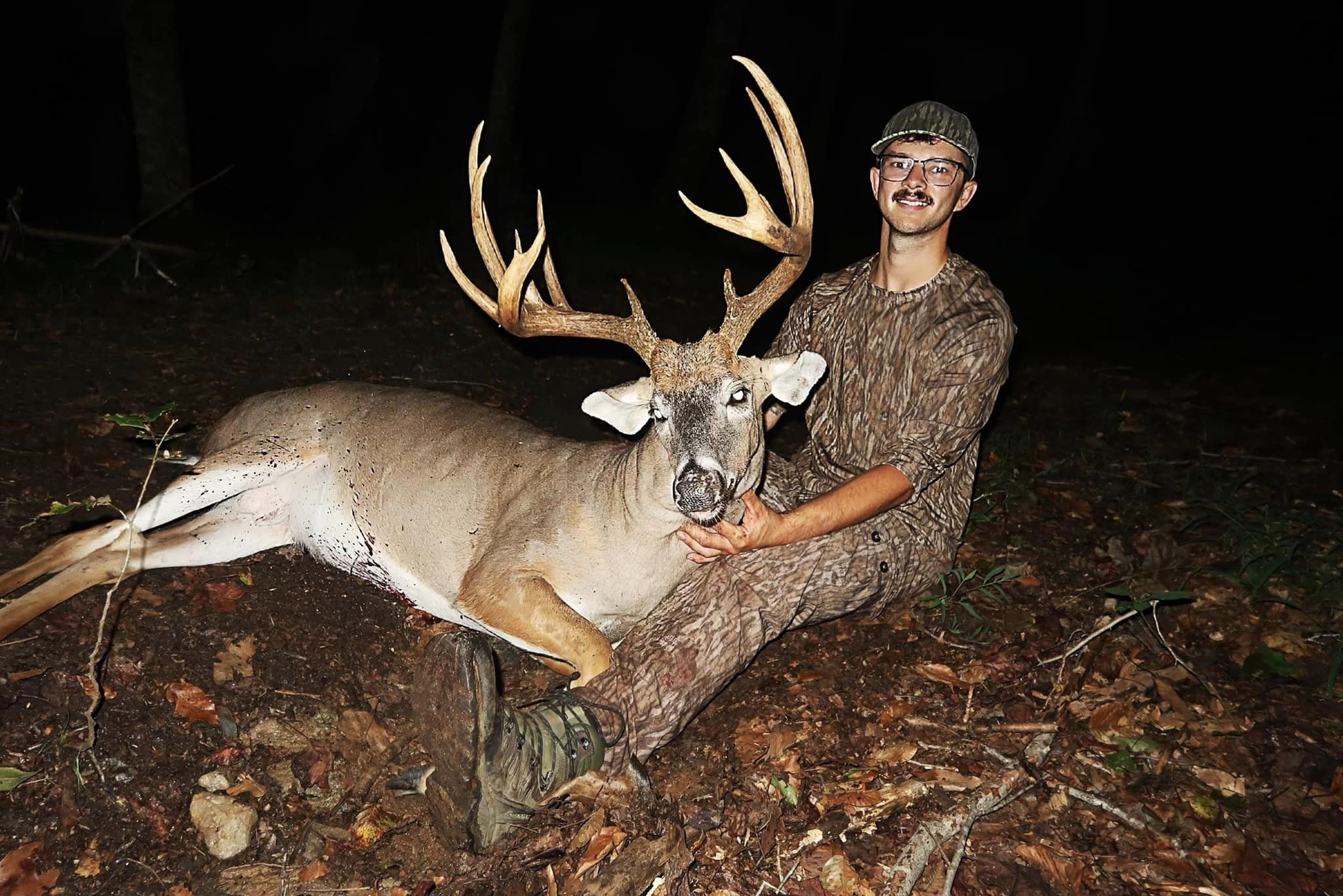A bowhunter holds up the head of a big North Carolina buck.