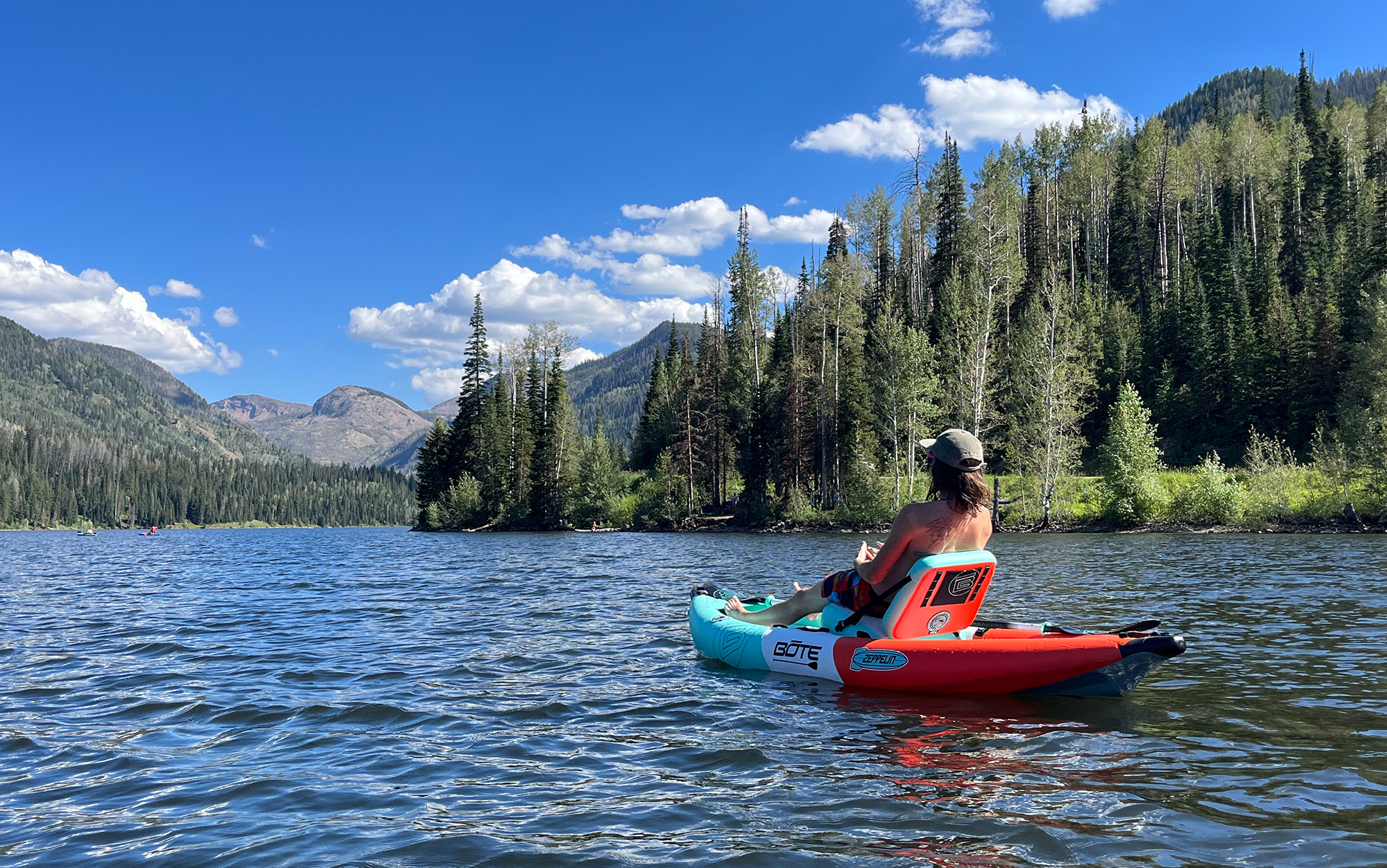 Man kayaks on a lake.