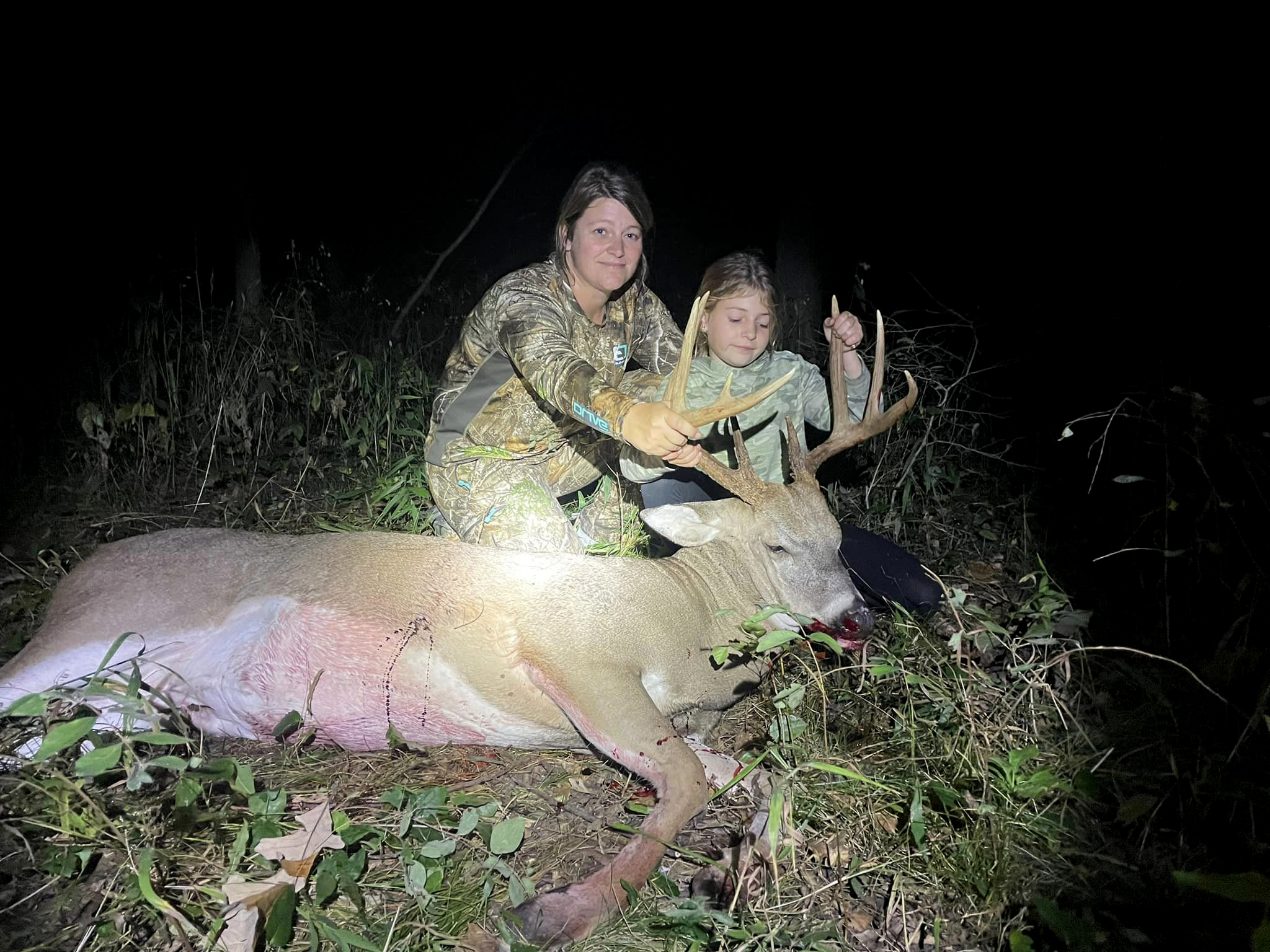 A mom and her daughter sit beside a nice Indiana buck.