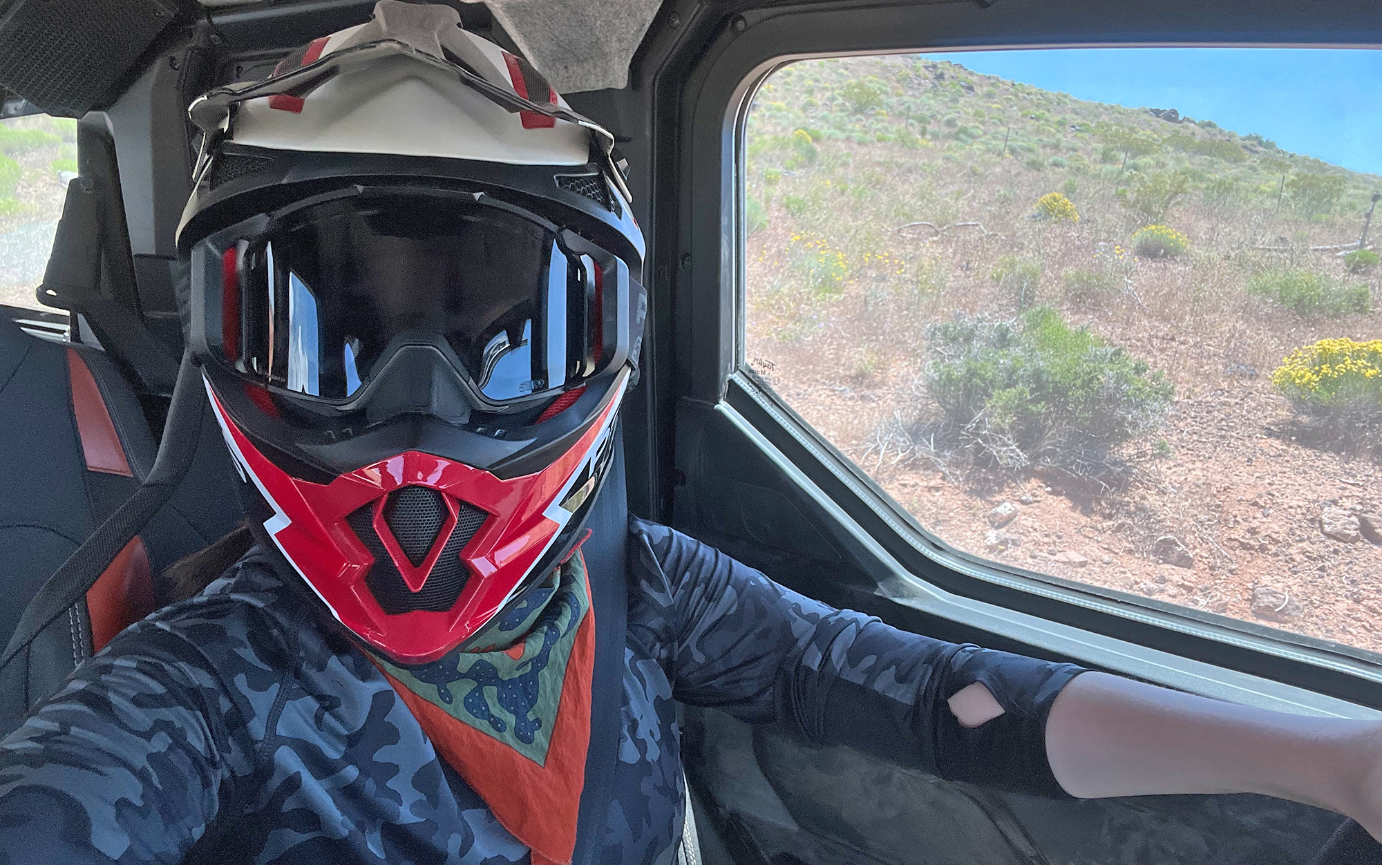 Rider wears a helmet in an ATV.
