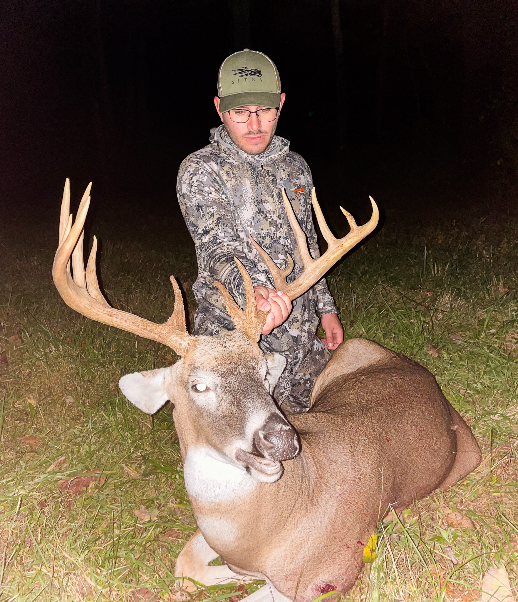 A hunter holds the antlers of a nice buck.