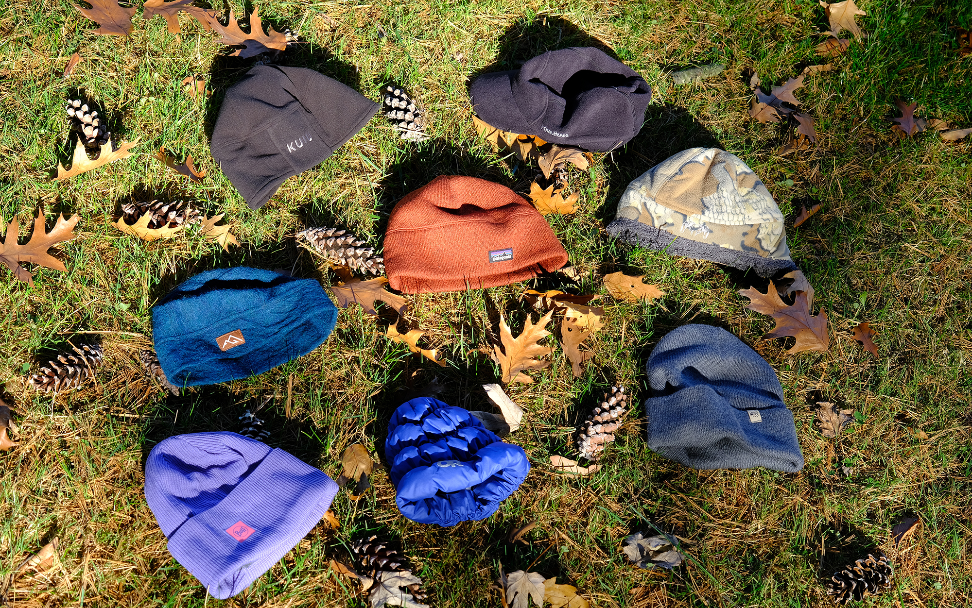 The best winter hats sit in the grass.