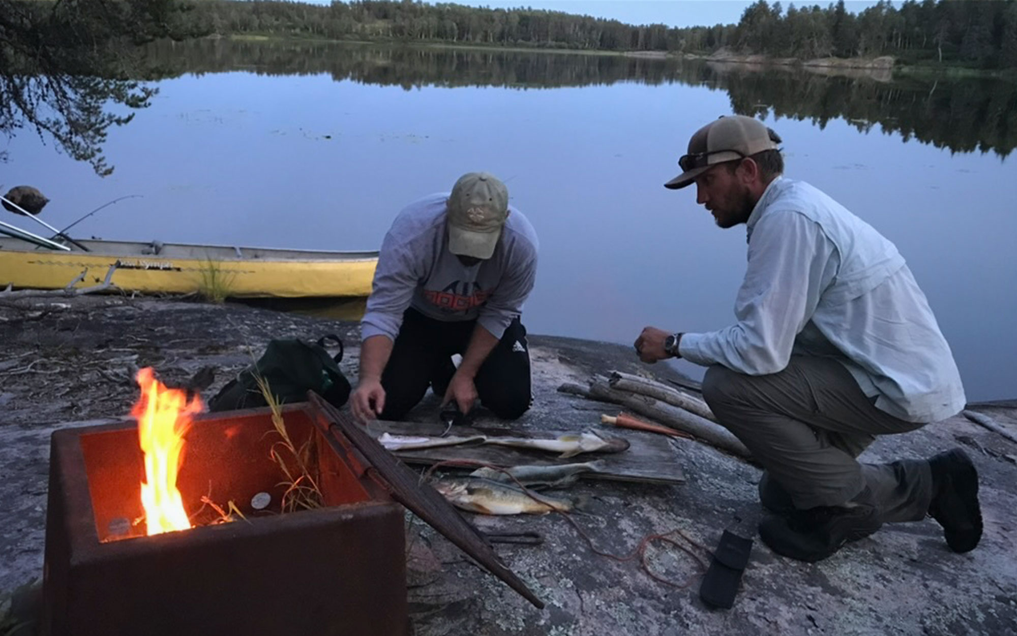 Campers grill walleye in the backcountry.