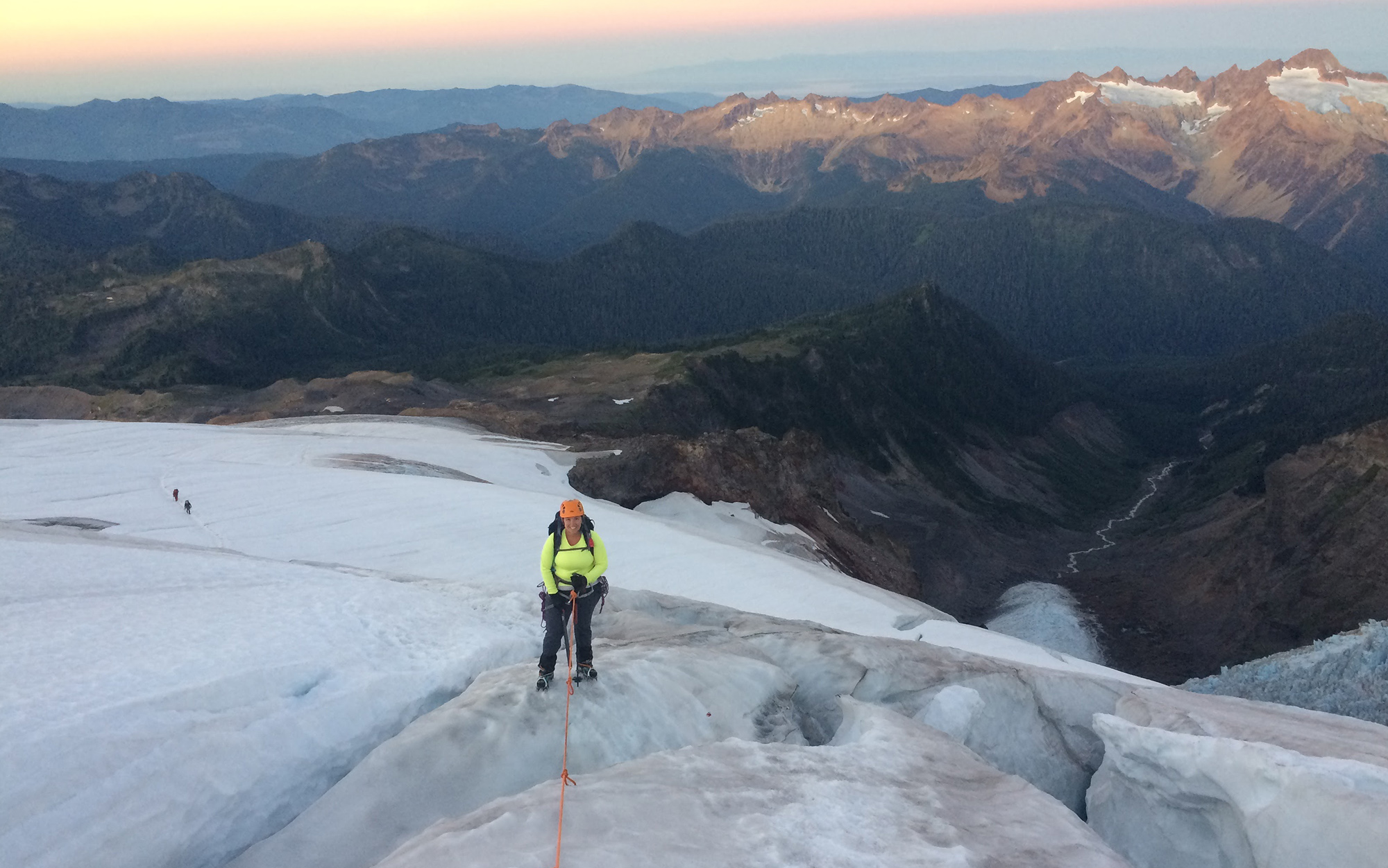 Hiker walks across ice wearing Petzl Hybrid crampons.