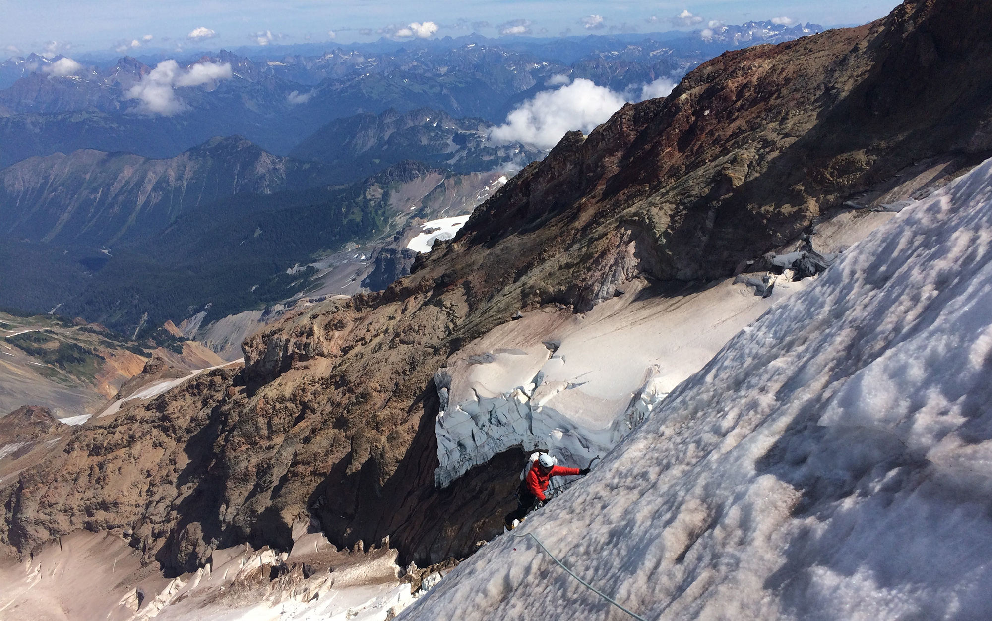 Ice climber traverses steep mountain side in Petzl Irvis Hybrid.