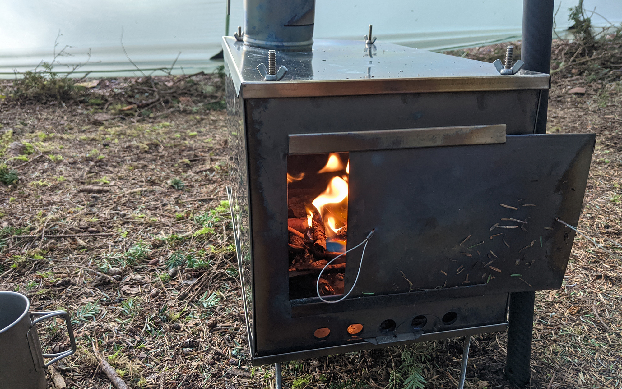 A Seek Outside Cimarron shows that you can have a wood-burning stove as part of an ultralight setup.
