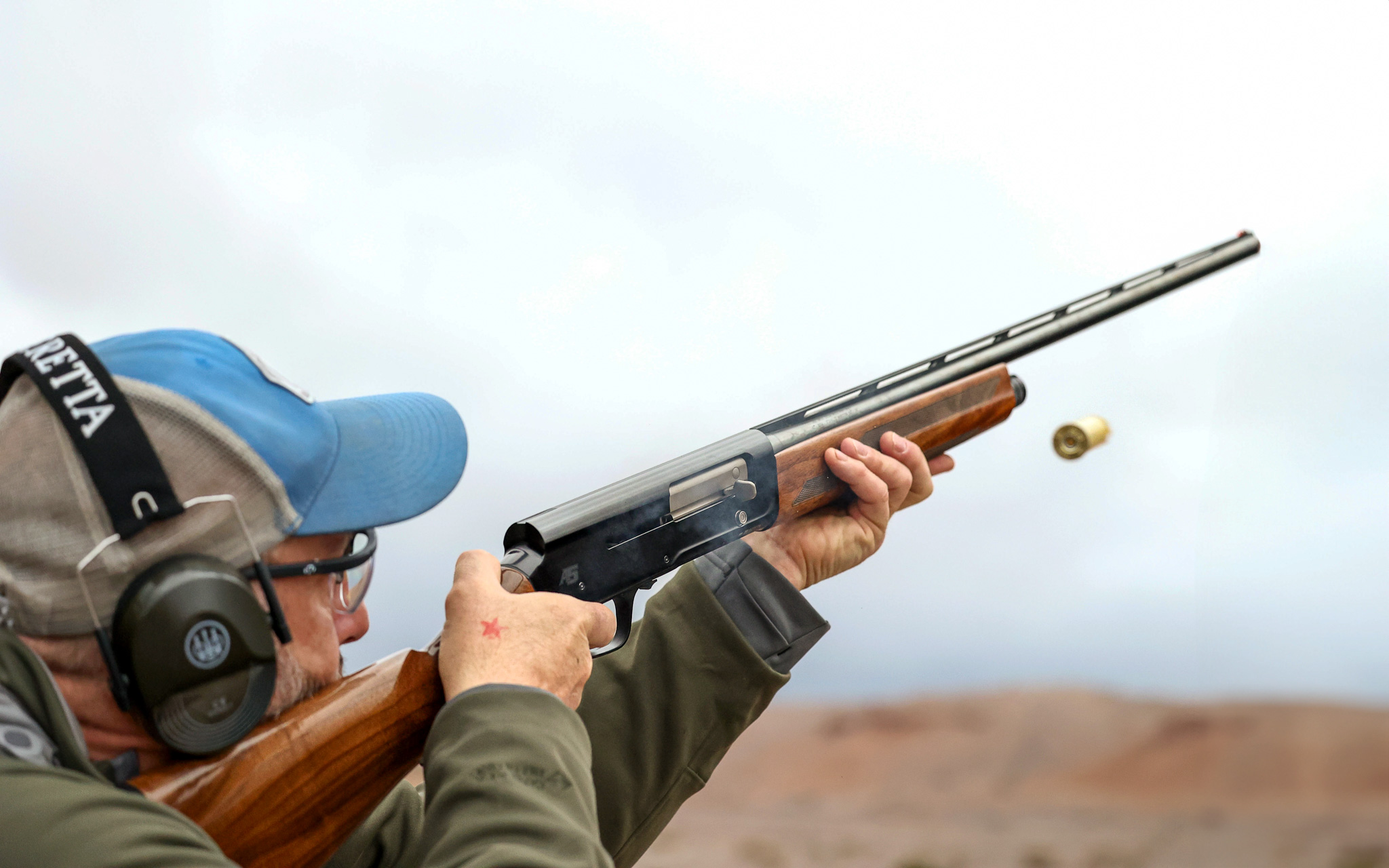 A man wearing ear and eye pro shoots a new Browning A5 in 20 gauge.