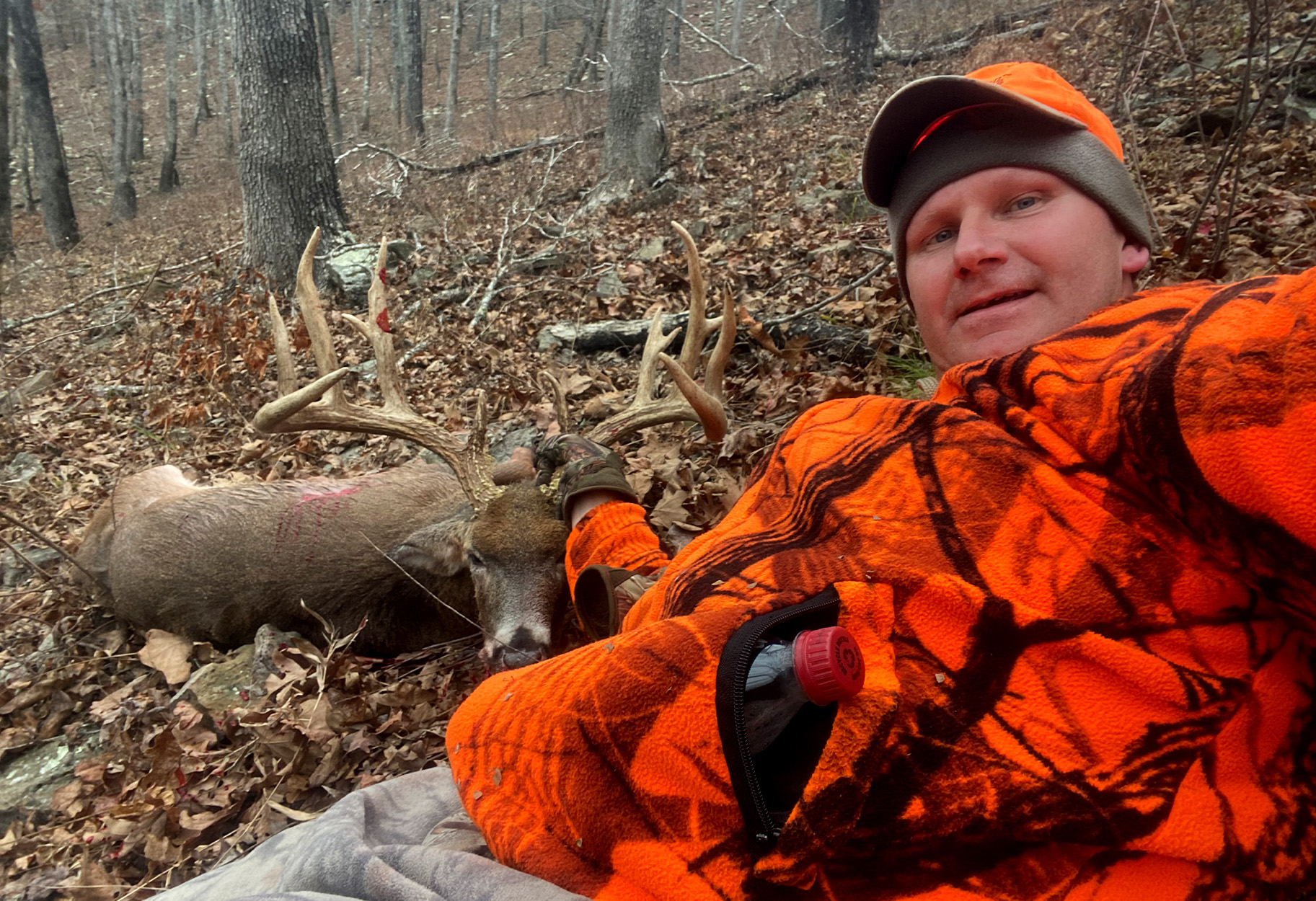 An Arkansas deer hunter takes a selfie with the biggest buck he's ever killed.