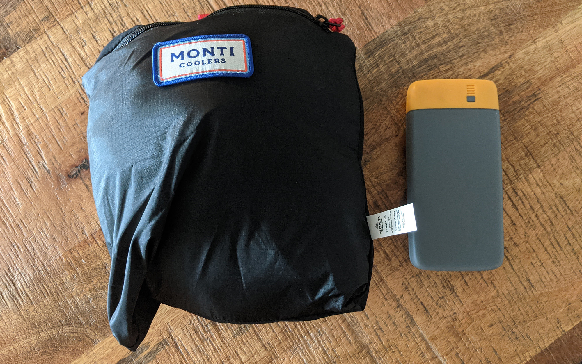 The Monti Cooler, next to a power bank for scale, squishes down to a surprisingly small size. 