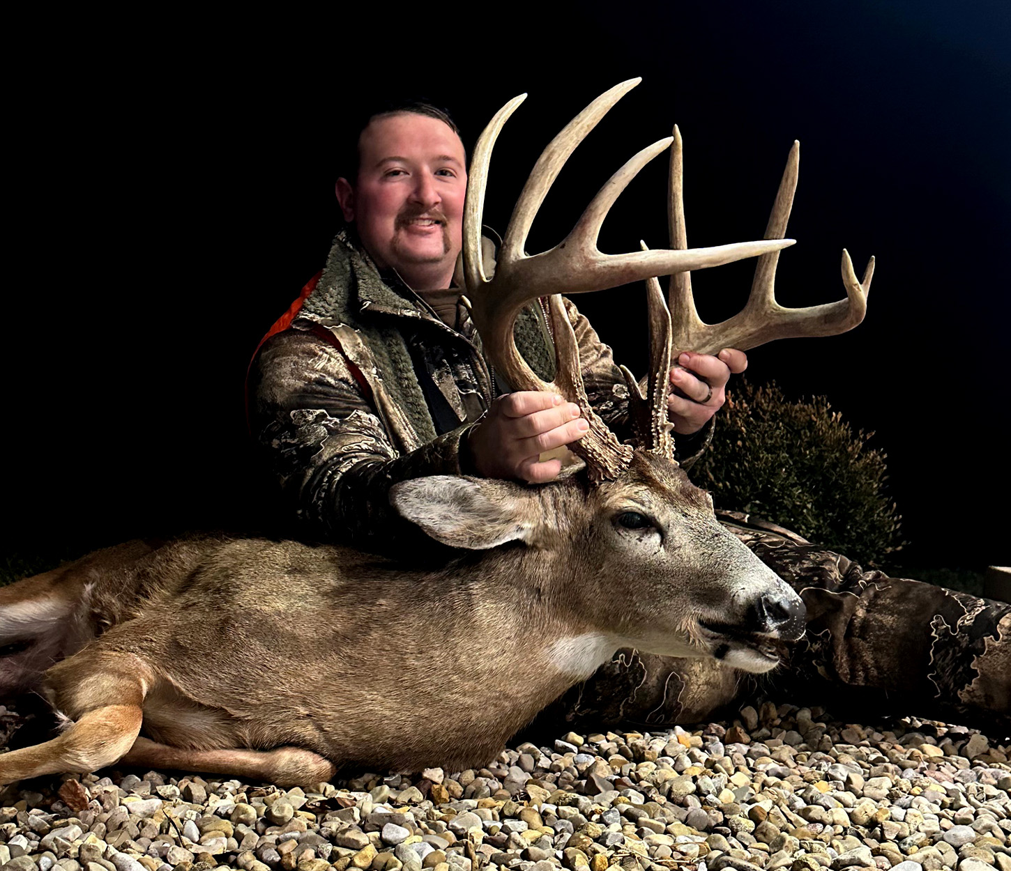 A hunter holds up a mature, 13-point buck killed in Ohio.