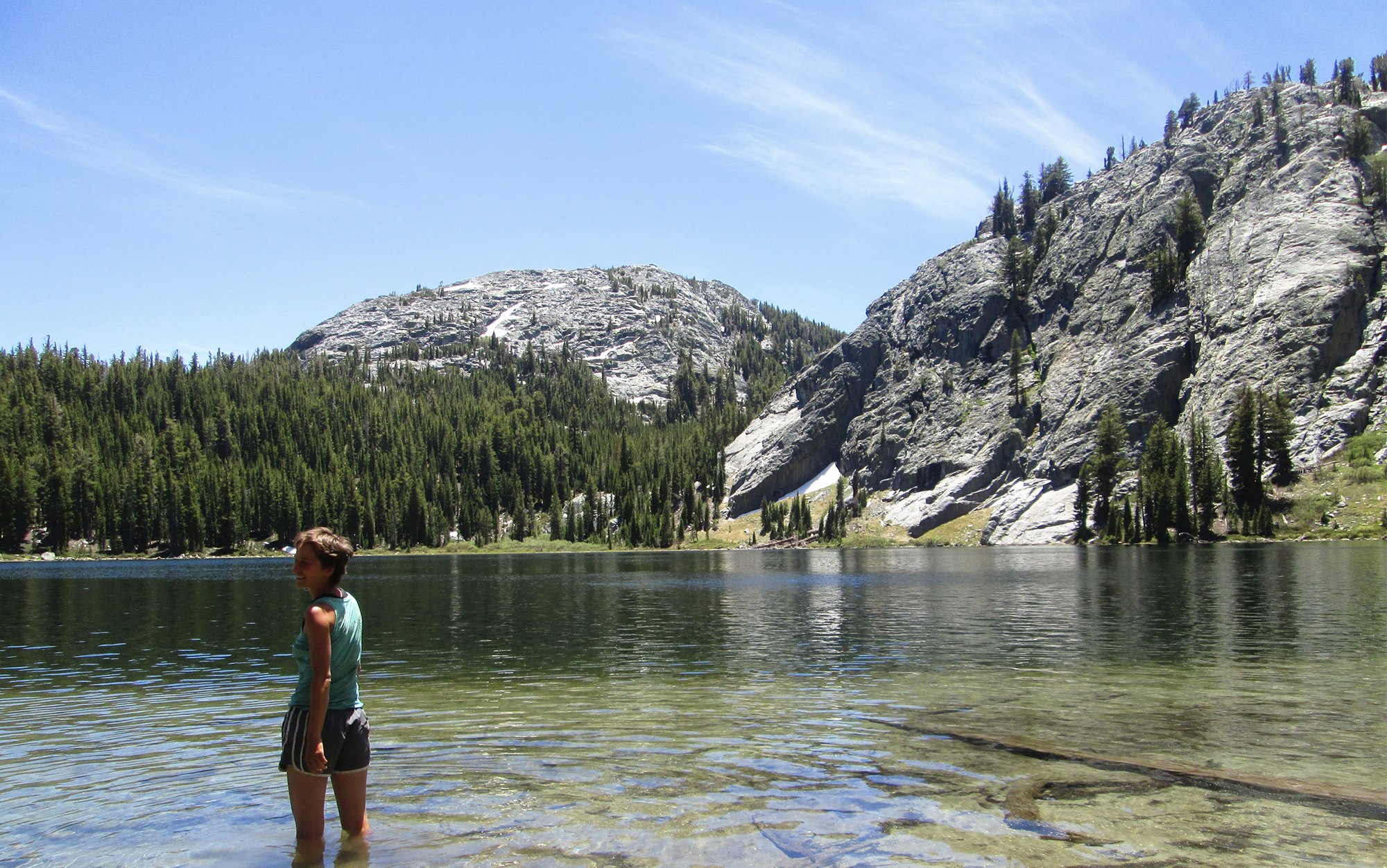 Woman standing in a lake in the High Sierra