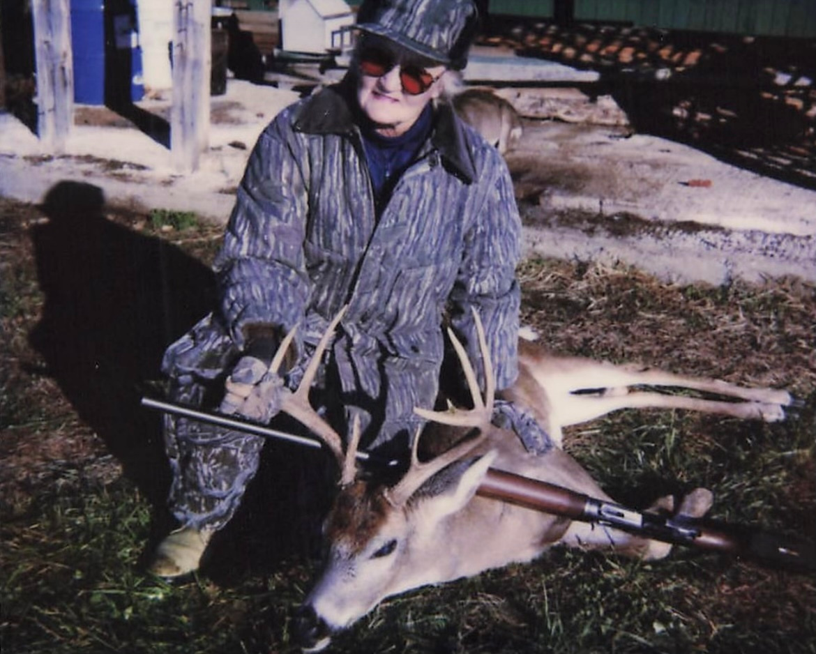 Charleen Parten poses with a whitetail buck and her gun. 
