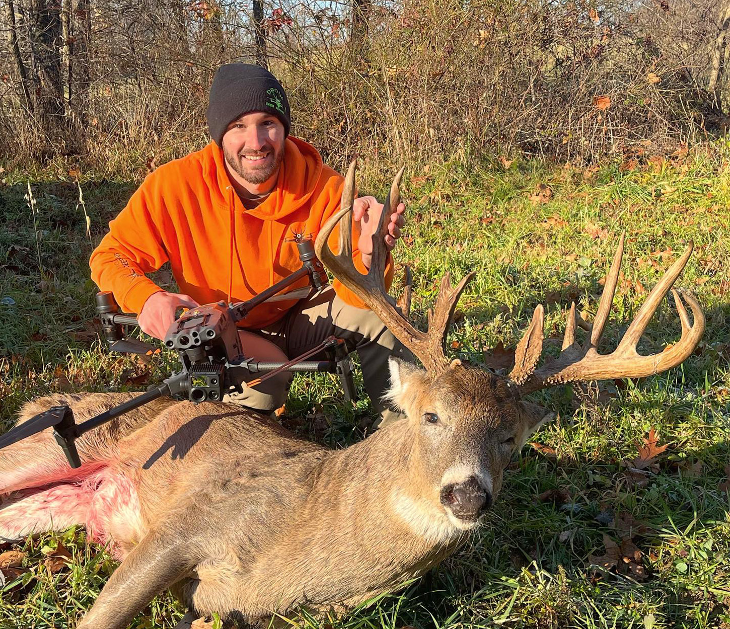 A man poses with a big whitetail buck.
