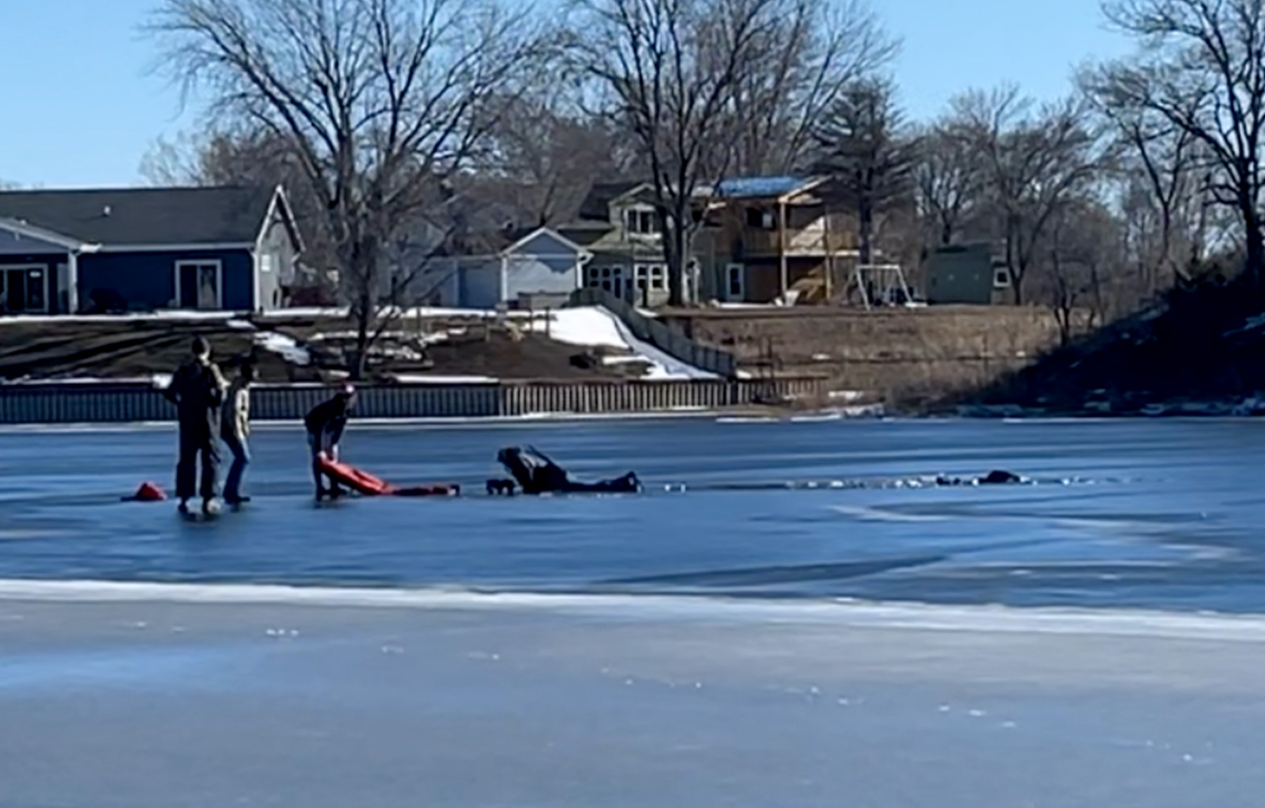 A group of ice fishermen rescue an angler who fell through the ice.
