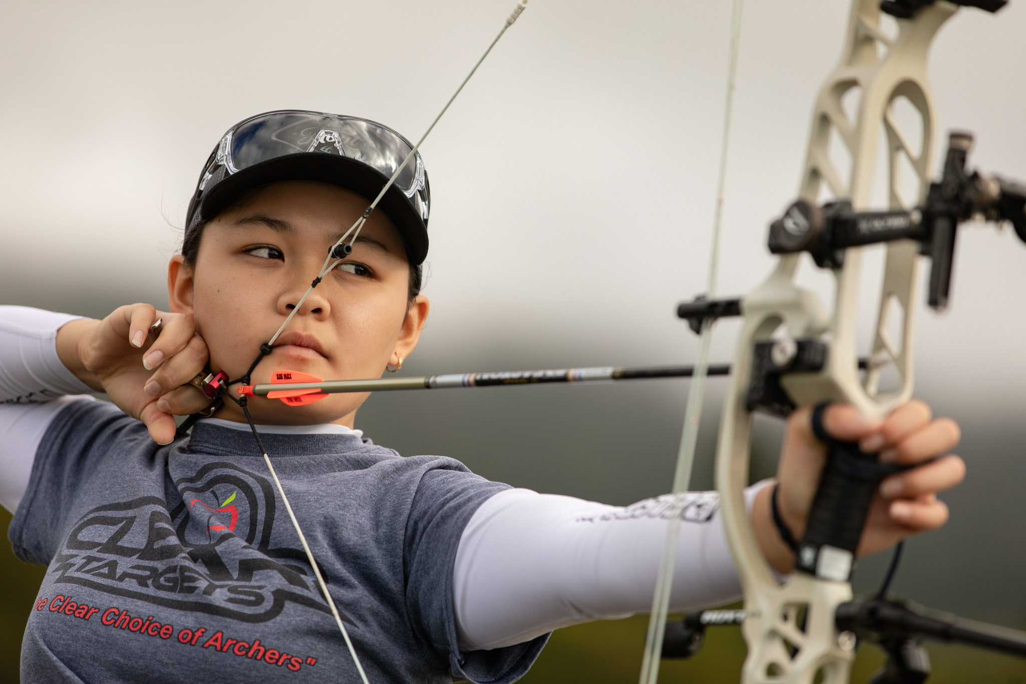 A portrait of archer Liko Arreola shooting her bow at home on Maui.