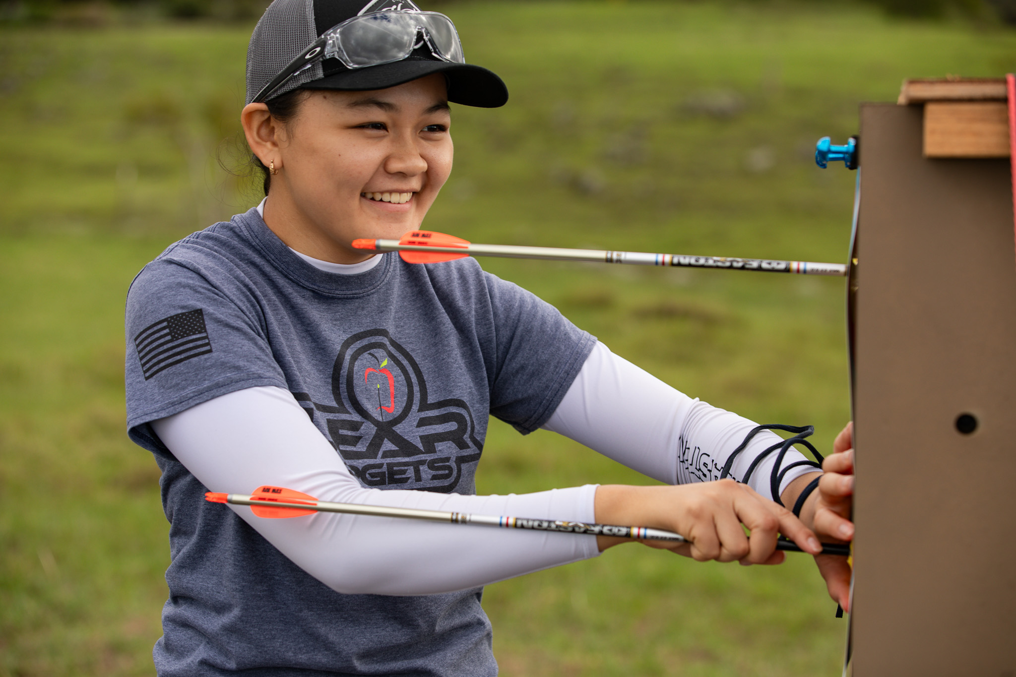 Liko Arreola smiling while pulling arrows from her target.